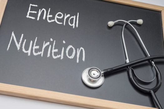 Enteral nutrition written on a blackboard, conceptual image, horizontal composition