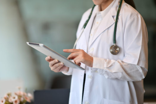 Cropped shot of doctor using a digital tablet in a medical facility.